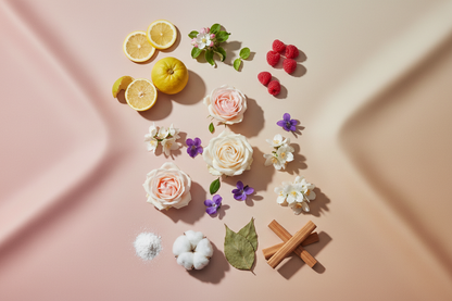 generate a  modern product image displaying the following individual notes, with a pink/beige/taupe background: lemon, apple blossom, bergamot, raspberry, rose, violet, jasmine, white musk, patchouli, sandalwood